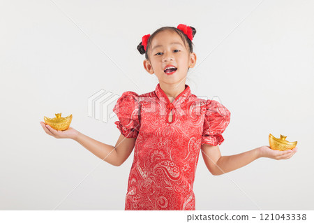 Happy Chinese New Year Smiling Asian girl wearing a red cheongsam dress holds a gold ingot, symbolizing wealth and prosperity. Isolated on a white background, festive and traditional Happy Chinese New Year Smiling Asian girl wearing a red cheongsam dress holds a gold ingot, symbolizing wealth and prosperity. Isolated on a white background, festive and traditional 121043338