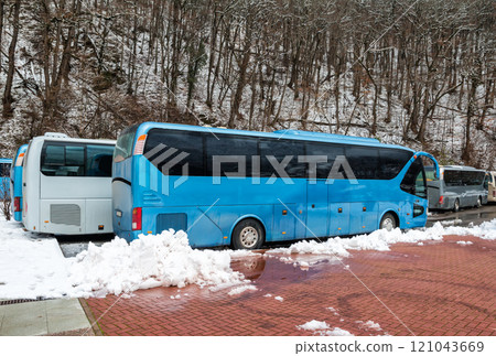 Intercity buses parked near the mountain forest at winter 121043669