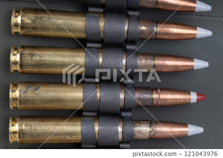 .50 BMG caliber machine gun ammunition belt with cartridges in ammunition can. .50 BMG caliber machine gun ammunition belt with cartridges in ammunition can. 121043976