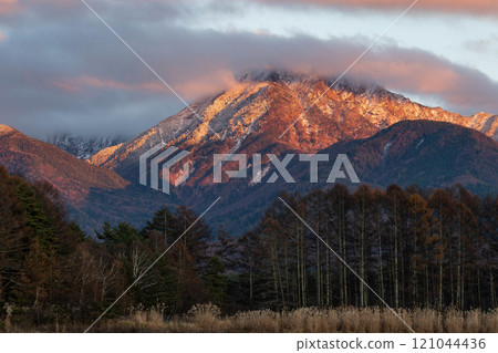 Mt. Amida in the evening glow as the clouds clear to reveal the frost-covered mountainside 121044436