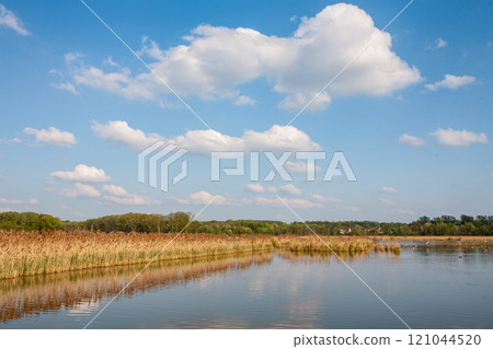 A Beautiful Serene Landscape Featuring a Brilliant Blue Sky and Calm, Peaceful Waters A Beautiful Serene Landscape Featuring a Brilliant Blue Sky and Calm, Peaceful Waters 121044520