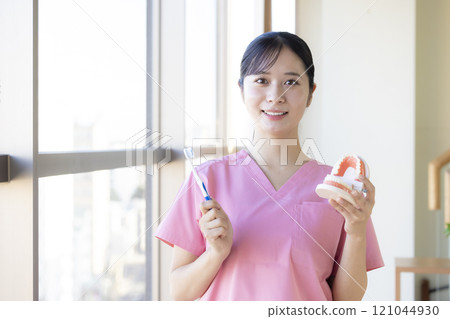 Dental hygienist who teaches tooth brushing 121044930