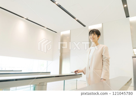A woman passing through the security gate at the office A woman passing through the security gate at the office 121045780