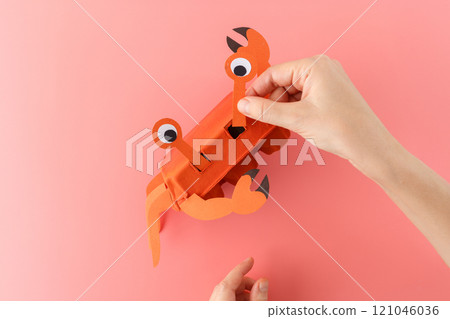 DIY crab craft made from orange painted egg carton and paper cutouts. Step-by-step collage on a pink background. Craft project for kids, DIY crab craft made from orange painted egg carton and paper cutouts. Step-by-step collage on a pink background. Craft project for kids, 121046036