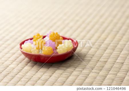 Red small plate and colorful confetti on tatami with copy space Red small plate and colorful confetti on tatami with copy space 121046496