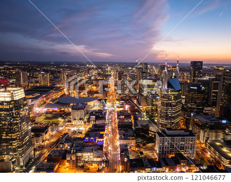 Nashville's stunning cityscape shines during a gorgeous sunset, highlighting the iconic ATandT building, Batman building, and Broadway Street with vibrant entertainment scene Nashville's stunning cityscape shines during a gorgeous sunset, highlighting the iconic ATandT building, Batman building, and Broadway Street with vibrant entertainment scene 121046677