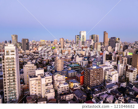 Dusk enveloping the Tokyo skyline highlights a fusion of modern high rises and historic buildings, showcasing the city's vibrant urban landscape and architectural diversity Dusk enveloping the Tokyo skyline highlights a fusion of modern high rises and historic buildings, showcasing the city's vibrant urban landscape and architectural diversity 121046682