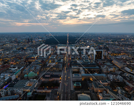 Berlin cityscape at dusk, aerial view of illuminated streets with traffic, Tiergarten Park, Alexanderplatz against a cloudy sky Berlin cityscape at dusk, aerial view of illuminated streets with traffic, Tiergarten Park, Alexanderplatz against a cloudy sky 121046690