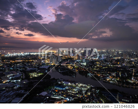 Manila skyline and Pasig River illuminated by a stunning sunset, with enchanting clouds adding a magical touch to the cityscape 121046826
