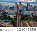 Dusk view of Manila's cityscape showcasing modern skyscrapers, busy streets, and green areas, highlighting urban development in the capital of the Philippines 121046856