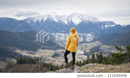 Female hiker on the top of the mountain enjoying the view on snowy peak in background, Austrian Alps Female hiker on the top of the mountain enjoying the view on snowy peak in background, Austrian Alps 121046946