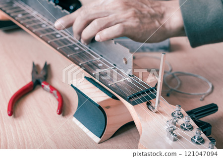 guitar repair, adjustment concept 121047094