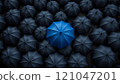 Blue umbrella standing out from the crowd of black umbrellas 121047201