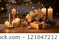 Bouquet of peach roses and gifts on table with burning candles illuminating romantic atmosphere 121047212