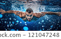 Male swimmer practicing swimming in a blue pool 121047248