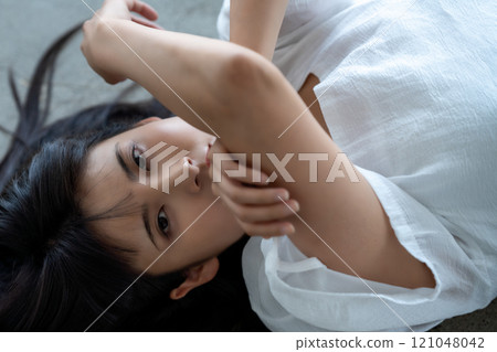 Young woman lying on flooring Young woman lying on flooring 121048042