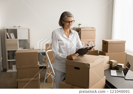 Positive delivery service office employee counting parcels 121048091