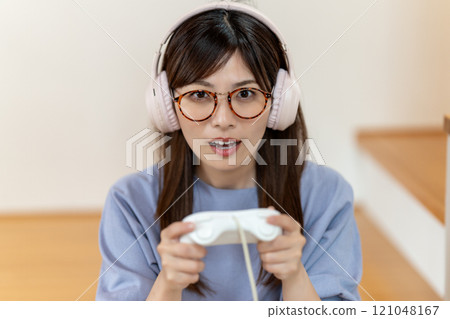 Middle-aged woman enjoying a game Middle-aged woman enjoying a game 121048167