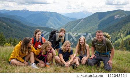 Group of friends and father hiking in mountains, sitting on grass, enjoying nature, wearing backpacks, surrounded by scenic landscape, green hills, and distant peaks, sunny day, outdoor adventure 121048534