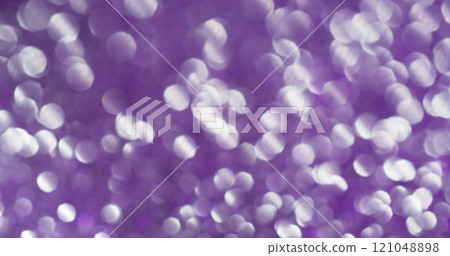 Blur flare. Purple sequins. Variable dispersion with illuminated light spots. Festive violet background with airy mystical glitter. Blur flare. Purple sequins. Variable dispersion with illuminated light spots. Festive violet background with airy mystical glitter. 121048898
