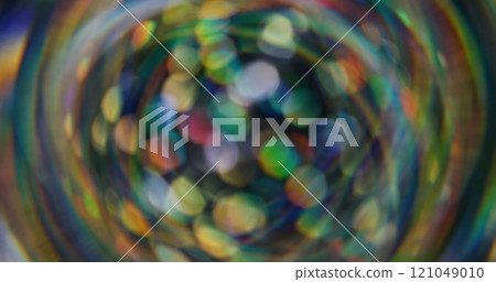 Blurred holographic confetti. Bokeh light. Defocused leak multicolor green yellow rays rainbow flickers beam lens flare on abstract art background. 121049010