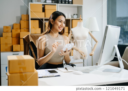 Startup small business SME, Entrepreneur owner woman using smartphone or tablet taking receive and checking online Startup small business SME, Entrepreneur owner woman using smartphone or tablet taking receive and checking online 121049171