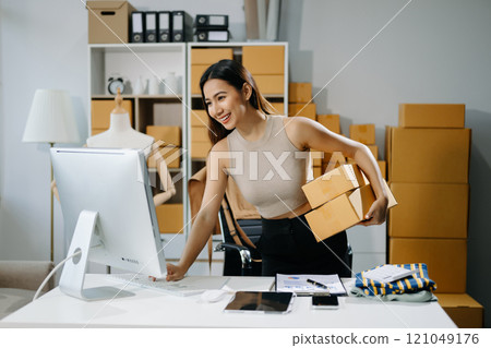 Startup small business SME, Entrepreneur owner woman using smartphone or tablet taking receive and checking online Startup small business SME, Entrepreneur owner woman using smartphone or tablet taking receive and checking online 121049176