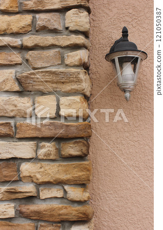 Brick Wall and Lamp on Outdoor of Residential Home 121050387