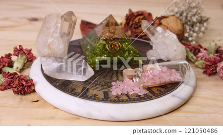 Pyramid With Crystals and Dried Flowers on Antique Sundial 121050486