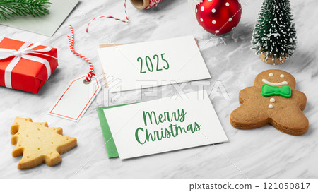 Merry christmas holiday card and green envelope with gingerbread man and christmas decor on marble table background Merry christmas holiday card and green envelope with gingerbread man and christmas decor on marble table background 121050817