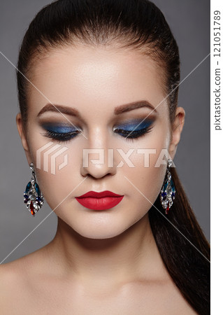 Closeup of Beautiful Woman with Celebrate Makeup, Luxury Accessories, Fashion Hairstyle 121051789