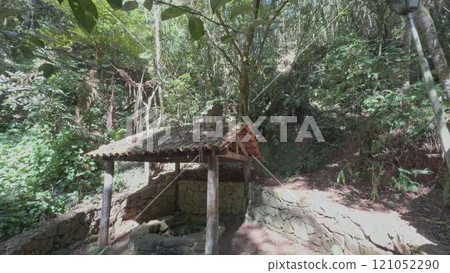 Camera Panning from Restored Old Water Well to Majestic Dense Jungle 121052290