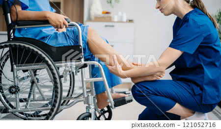 Physiotherapist helping elderly man patient stretching arm during exercise correct with dumbbell in hand during training hand with patient Back problems 121052716