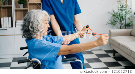 Physiotherapist helping elderly man patient stretching arm during exercise correct with dumbbell in hand during training hand with patient Back problems 121052718