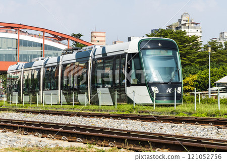 The circular light rail train drives past Hamasen Railway Cultural Park in Kaohsiung, Taiwan. 121052756