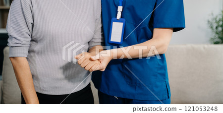 Female hands touching senior male hand Helping hands take care of the elderly concept in hospital Female hands touching senior male hand Helping hands take care of the elderly concept in hospital 121053248