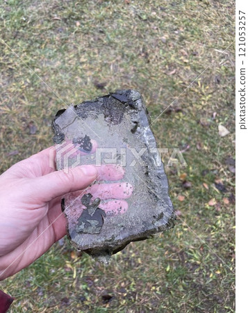 Frozen block of ice in hand 121053257