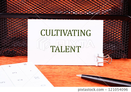 Business concept. Conceptual phrase CULTIVATING TALENT written on a white business card in close-up 121054096