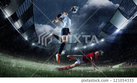 Female soccer player jumping gracefully to strike ball mid-air, captured in rain-soaked 3D-modeled stadium during competitive soccer match. 121054333