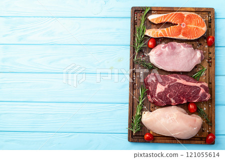 Mix of raw meat and fish . Salmon , beef , pork , chicken staek . Top view 121055614