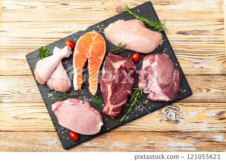 Mix of raw meat and fish . Salmon , beef , pork , chicken staek . Top view 121055621