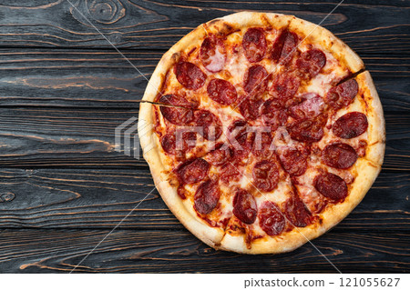 Pizza pepperoni fast food . Top view on rustic background 121055627