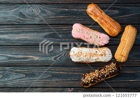 Assorted eclairs on a pastel top view Traditional French dessert 121055777