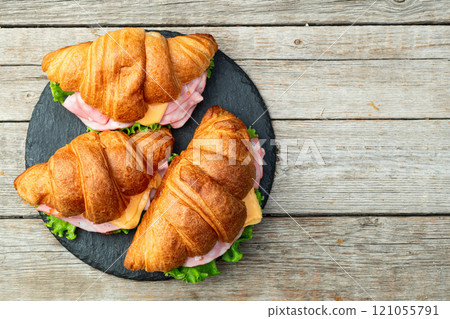 Croissant sandwich with salad ham and cheese . Top view 121055791
