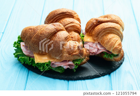 Croissant sandwich with salad ham and cheese . Top view Croissant sandwich with salad ham and cheese . Top view 121055794