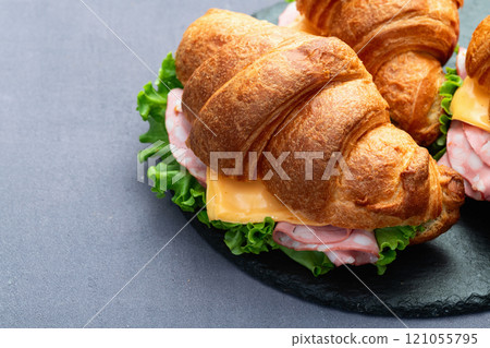 Croissant sandwich with salad ham and cheese . Top view 121055795