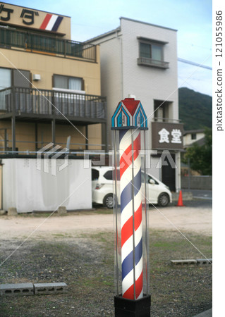 A barber shop sign in front of a local station A barber shop sign in front of a local station 121055986