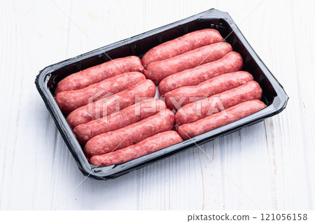 Raw beef sausages with rosemary and tomatoes photography . Top view Raw beef sausages with rosemary and tomatoes photography . Top view 121056158