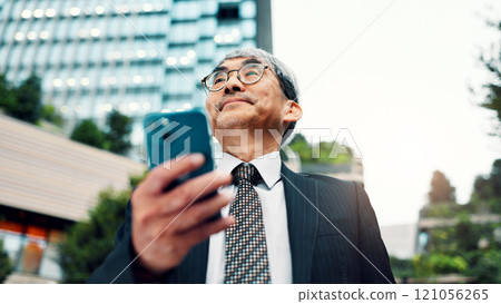 Mature, business and man with phone in city of communication, planning travel and schedule update. Thinking, person and low angle of negotiation feedback, location directions and information in Japan 121056265