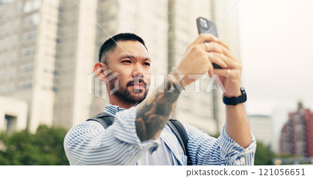 Man, phone and travel in city with photography for memory, location and mobile app on commute in street. Person, smartphone and outdoor for profile picture, post and social media on sidewalk in Japan 121056651
